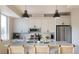 Bright kitchen with white cabinets, stainless steel appliances, and a center island with seating at 2197 S Clermont St, Denver, CO 80222