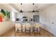 Modern kitchen island featuring white cabinets, stainless steel appliances, and pendant lighting at 2197 S Clermont St, Denver, CO 80222