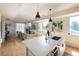 Open concept kitchen with center island flowing into living room with fireplace and natural light at 2197 S Clermont St, Denver, CO 80222