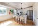 Modern kitchen with island seating, stainless steel appliances, and hardwood floors at 2197 S Clermont St, Denver, CO 80222