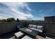 Relax on the rooftop deck offering plush seating, modern fire table, and a beautiful mountain view at 2197 S Clermont St, Denver, CO 80222
