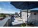 Enjoy this rooftop deck with comfortable seating, an umbrella, and beautiful views at 2197 S Clermont St, Denver, CO 80222
