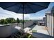 Relax under the umbrella on the rooftop deck, furnished with stylish seating and offering scenic views at 2197 S Clermont St, Denver, CO 80222
