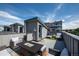 Relax on this rooftop deck featuring comfortable seating and an outdoor fire pit at 2197 S Clermont St, Denver, CO 80222