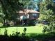Expansive lawn and patio, framed by mature trees and lush greenery, create a private oasis at 1650 Monaco St Pkwy, Denver, CO 80220