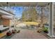 Backyard patio with brick flooring, seating area, grill, and lush green lawn at 1650 Monaco St Pkwy, Denver, CO 80220