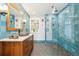 Stylish bathroom with blue tiled walls, a glass-enclosed shower, and unique vanity at 1650 Monaco St Pkwy, Denver, CO 80220