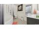 Modern bathroom with a walk-in shower, soaking tub, and patterned tile floor at 1650 Monaco St Pkwy, Denver, CO 80220