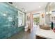 Bathroom boasts a walk-in shower, stylish sink, and access to sunroom at 1650 Monaco St Pkwy, Denver, CO 80220