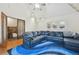 Spacious bedroom with hardwood floors, a large sectional sofa, and access to the upper floors at 1650 Monaco St Pkwy, Denver, CO 80220