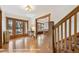 Hardwood floors, staircase, and view into dining area at 1650 Monaco St Pkwy, Denver, CO 80220