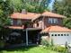 Brick house with red tile roof, balcony, and attached garage at 1650 Monaco St Pkwy, Denver, CO 80220