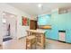 Kitchen features teal cabinets, stainless steel appliances, and butcher block island at 1650 Monaco St Pkwy, Denver, CO 80220