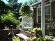 Landscaped side yard with brick wall, trellis, and bench at 1650 Monaco St Pkwy, Denver, CO 80220