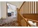 Wooden staircase with detailed banister leading to upper level at 1650 Monaco St Pkwy, Denver, CO 80220