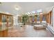 Bright sunroom with tiled floors, skylights, and ample natural light at 1650 Monaco St Pkwy, Denver, CO 80220