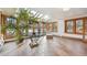 Bright sunroom with tiled floors, skylights, a large potted plant and lounge chair at 1650 Monaco St Pkwy, Denver, CO 80220