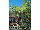 Beautiful apple tree in the front yard of a charming brick home with a tiled roof at 1650 Monaco St Pkwy, Denver, CO 80220