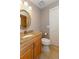 Classic bathroom with tiled floors, oval mirror, and granite countertop at 6468 S Hudson St, Centennial, CO 80121