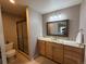 Well-lit bathroom featuring a granite countertop vanity and glass-enclosed shower at 6468 S Hudson St, Centennial, CO 80121