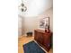 Bedroom with oak floors, decorative dresser and art with a vaulted ceiling, and a dark blue area rug at 6468 S Hudson St, Centennial, CO 80121
