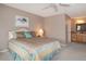 Cozy bedroom with ceiling fan, ensuite bathroom, and a decorative painting at 6468 S Hudson St, Centennial, CO 80121