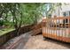 Outdoor view of a wooden deck with stone patio leading to stairs and dark metal patio furniture at 6468 S Hudson St, Centennial, CO 80121