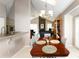 Open-concept dining area with stylish chandelier, seamlessly connecting to living space at 6468 S Hudson St, Centennial, CO 80121
