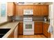 Spacious kitchen boasts wooden cabinets, granite counters and stainless steel appliances at 6468 S Hudson St, Centennial, CO 80121