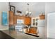 Well-lit kitchen featuring granite counters, wood cabinets, and modern appliances at 6468 S Hudson St, Centennial, CO 80121