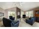 Cozy living room with stone fireplace, vaulted ceiling, and access to outdoor space at 6468 S Hudson St, Centennial, CO 80121