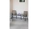Cozy screened in porch offers a relaxed seating area with two chairs and a decorative table at 6468 S Hudson St, Centennial, CO 80121
