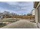Spacious backyard with a large concrete patio, lush landscaping, a wood fence, and room for outdoor activities at 21562 Omaha Ave, Parker, CO 80138