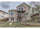 Multi-level backyard with a wooden deck, patio, mature trees, and well-maintained lawn offering relaxation and privacy at 21562 Omaha Ave, Parker, CO 80138