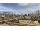 Overhead view of a fenced backyard featuring a trampoline, mature trees, and mountain views beyond the neighborhood at 21562 Omaha Ave, Parker, CO 80138