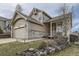 Charming home with a two-car garage, and inviting front porch with stone retaining wall at 21562 Omaha Ave, Parker, CO 80138