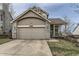 Charming home featuring a two-car garage, neutral paint, brick accents, and a cozy front porch at 21562 Omaha Ave, Parker, CO 80138