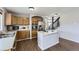 Spacious kitchen featuring stainless steel appliances, an island with a cooktop, and wood cabinetry at 21562 Omaha Ave, Parker, CO 80138