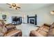 Spacious living room with ample seating, fireplace and built in tv console near a window at 21562 Omaha Ave, Parker, CO 80138