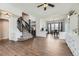 Hardwood floors connect the living room, dining area, and staircase in this well-designed home at 21562 Omaha Ave, Parker, CO 80138