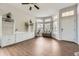Bright living room with beautiful hardwood floors, large windows, and built-in shelving at 21562 Omaha Ave, Parker, CO 80138