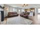 Open living room with fireplace and view of kitchen including wood cabinets at 21562 Omaha Ave, Parker, CO 80138