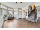 Bright living room with hardwood floors, a large bay window, and elegant staircase at 21562 Omaha Ave, Parker, CO 80138