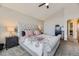 Main bedroom featuring a tufted headboard with floral patterned bedding and vaulted ceilings at 21562 Omaha Ave, Parker, CO 80138