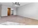 Well-lit bedroom with neutral carpet, ceiling fan, and closet at 9155 E Center Ave # 3C, Denver, CO 80247