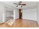 Bright bedroom with hardwood floors, a ceiling fan, and ample closet space at 9155 E Center Ave # 3C, Denver, CO 80247