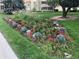 Landscaped flower bed with various flower types and green plants lining the path to the property at 9155 E Center Ave # 3C, Denver, CO 80247