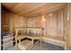 This is an indoor wooden sauna with multiple levels of seating and a Harvia heater at 9155 E Center Ave # 3C, Denver, CO 80247