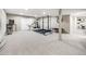 Spacious home gym in the basement featuring wall-mounted storage and equipment at 62 N Ranch Rd, Littleton, CO 80127