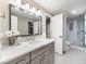 Contemporary bathroom with a large mirror and a walk-in shower with glass doors at 62 N Ranch Rd, Littleton, CO 80127